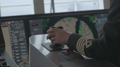Captain steers the ship by azimuth controller. Hand turns the joystick of the Vidéo 148162214