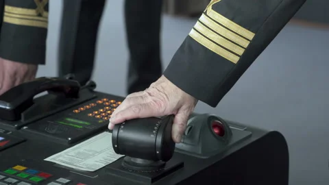Captain steers ship by azimuth controller. Hand turns joystick of azipod control Stock Footage 218603295