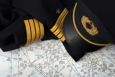 Captain uniform and navigation chart Stock Photos