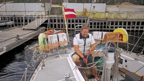 Captain on a yacht behind steering wheel Stock Footage