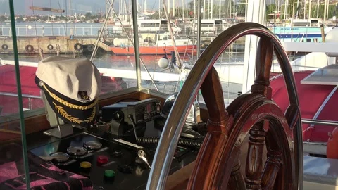 Captains cap on the wheelhouse console of a vessel on the berth Stock Footage 112276591