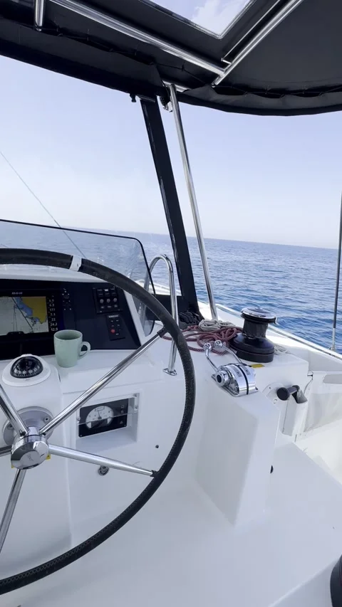 Captain’s Feet at Sailing Catamaran Helm During Day Trip in Greece Stock Footage 336965010
