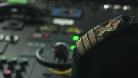Captain's shoulder strap, control panel of ship on background. Green buttons Stock Footage 218586494