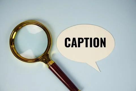 Caption text on speech bluble with magnifying glass top view on blue backgrou Stock Photos