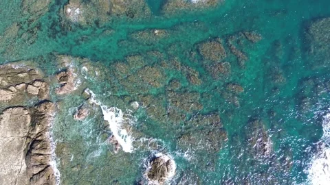 Captivating 4K Bird's Eye View: Drone Soars Above the Rocky Ocean Waves Stock Footage 257791654