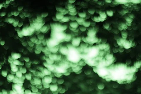 A captivating abstract background featuring a green bokeh effect. The image s Stock Photos