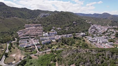 Captivating aerial panoramic view of a charming town nestled amidst majestic Stock Footage 278539087