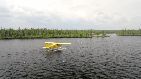 Captivating Aerial Perspective as Yellow Beaver Seaplane Taxis Toward Stock Footage 250226940
