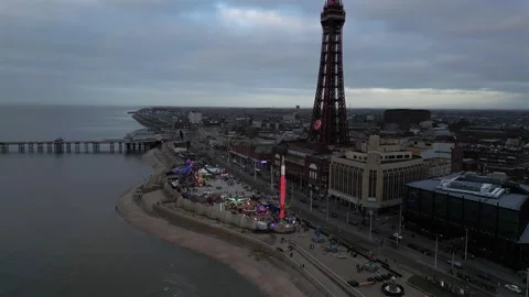 Captivating aerial view of Blackpool Tower and festive seaside amusement park Stock Footage 328704244