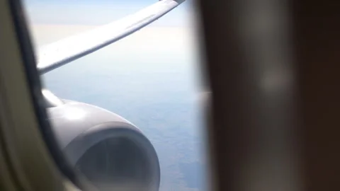 Captivating Aerial View of the Landscape Below Through an Airplane Window i.. Stock Footage 260233688