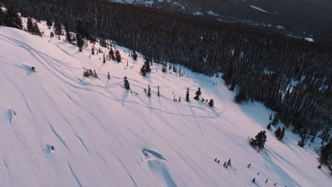 Captivating aerial view of snow-covered mountain landscape at sunset Stock Footage 309900282