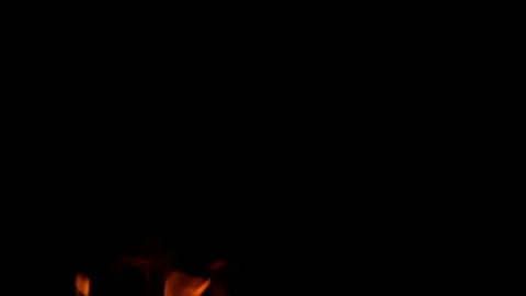Captivating and Enchanting Flames Dancing Gracefully in the Completeness of the Stock Footage 311815441
