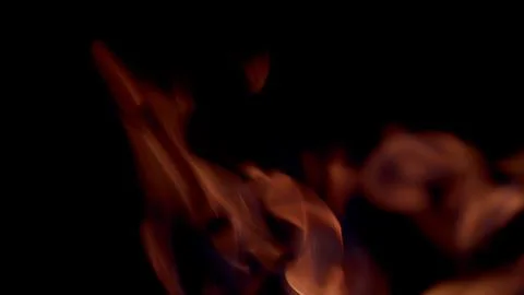 The captivating and mesmerizing flames are dancing gracefully in the surrounding 写真素材