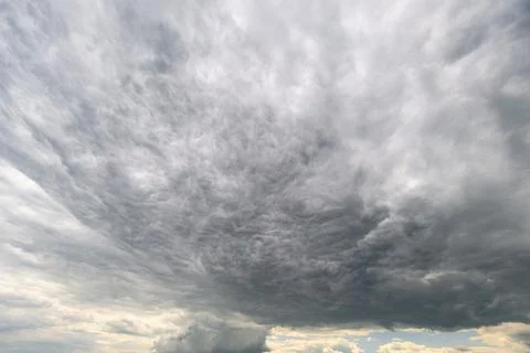 A captivating and mesmerizing view of dark, swirling clouds ominously signali 写真素材