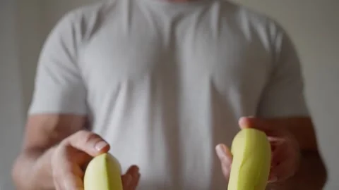 Captivating Bananas in Hands A Unique and Engaging Perspective on Bright Produce Stock Footage 311052144