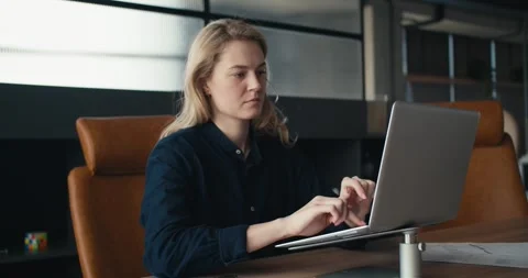 Captivating Blonde Professional: Engaging Office Presence and Contemplative Stock Footage 242900201