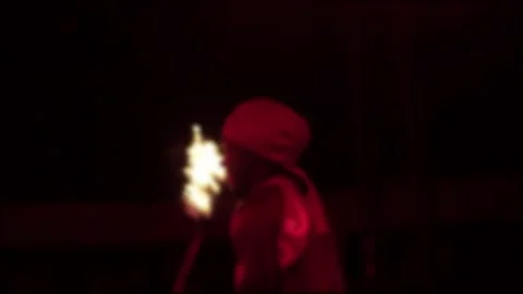 Captivating blurred fire performance by one person holding flaming torch during Stock-Footage 342923280