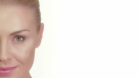 Captivating close-up of a beautiful model's face against a pristine white Stock Footage 311674332