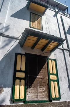 Captivating close up of an old building facade, featuring traditional green.. Stock Photos