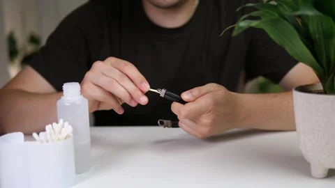 Captivating close-up of skilled hands performing delicate jewelry maintenance, a Stock Footage 314424530