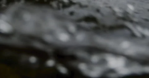 Captivating Close-Up: Slow-Motion Flow of River Current Through beautiful and Stock Footage 240942278