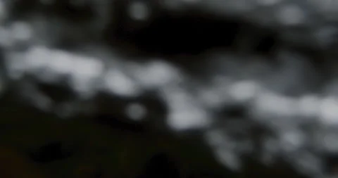 Captivating Close-Up: Slow-Motion Flow of River Current Through beautiful and Stock Footage 240943852