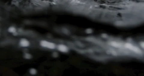 Captivating Close-Up: Slow-Motion Flow of River Current Through beautiful and Stock Footage 240944250