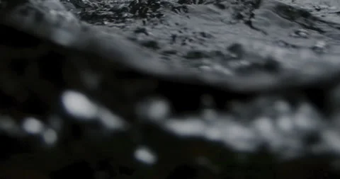 Captivating Close-Up: Slow-Motion Flow of River Current Through beautiful and Stock Footage 240944574