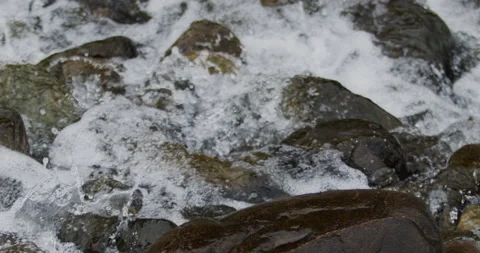 Captivating Close-Up: Slow-Motion Flow of River Current Through Stunning Rocks Stock Footage 240947843