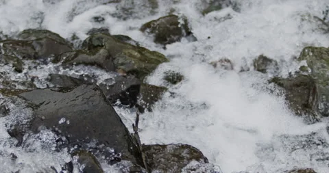 Captivating Close-Up: Slow-Motion Flow of River Current Through Stunning Rocks Stock Footage 240947844