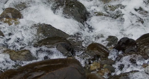 Captivating Close-Up: Slow-Motion Flow of River Current Through Stunning Rocks Stock Footage 240950975