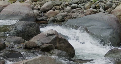 Captivating Close-Up: Slow-Motion Flow of River Current Through Stunning Rocks Stock Footage 240951851