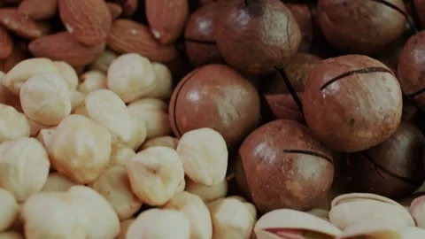 A captivating close up view of assorted nuts slowly rotating, showcasing th.. Stock Footage 334768292