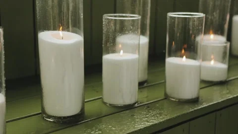 A captivating collection of glowing candles placed on a vibrant green surface Stock Footage 318065995