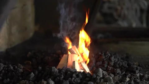 A Captivating Display of Fire's Dance: Flames Flicker and Glow Amidst Charcoal 库存影片 341316725