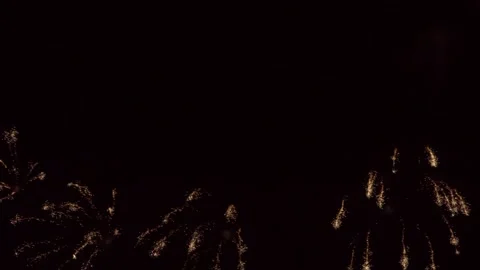 Captivating display of golden fireworks lighting up the dark sky captured in Stock Footage 330377037