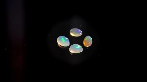 Captivating Display of Iridescent Opal Gems Against a Dark Background Stock Footage 302188773