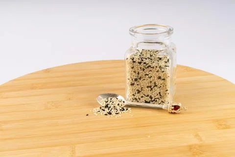 A captivating display of mixed white and black sesame seeds in a clear glas.. Stock Photos