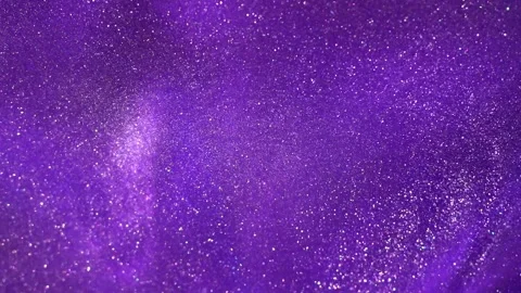 The Captivating Display of White Glitter Particles in Fluid Motion. Purple Stock Footage 243608240