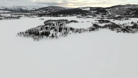 Captivating drone shot aerial view of a pristine snowy landscape in Norway, Stock Footage 330376570