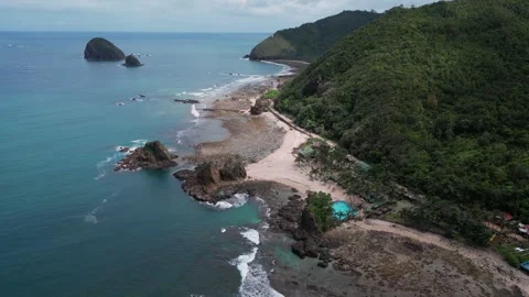 A captivating drone shot captures a winding road running parallel to the sand Stock-Footage 304308152