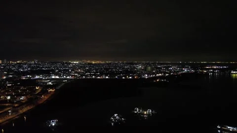 Captivating Evening Drone View Showcasing an Illuminated Metropolis Beside .. Stock-Footage 325203892