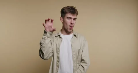 Captivating expressions of a man exploring playful emotions in a cozy indoo.. Vídeo Stock 329113068