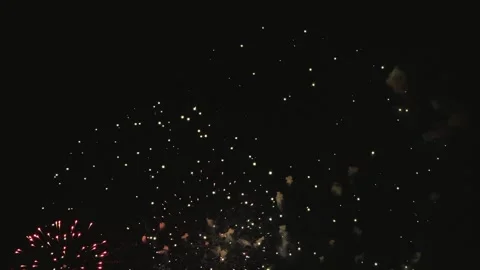Captivating fireworks burst in a sparkling display against a dark night sky, Stock Footage 330377043