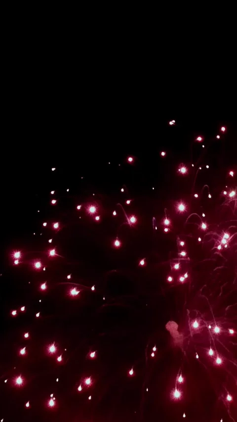 Captivating fireworks display lights up the night sky in vibrant red hues Video stock 299459699
