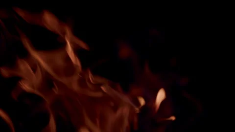 The Captivating Flames Dance Gracefully Against a Dark Background, Creating Ench Stock Footage 310572016