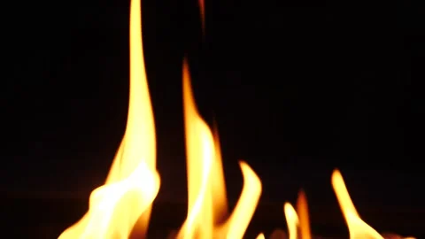 Captivating flames dancing against a dark background at night Stock Footage 281816114