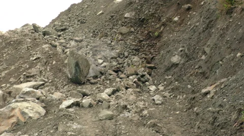 Captivating footage of a massive boulder dramatically tumbling down a steep Stock Footage 52896451