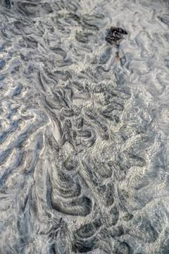 A captivating high-angle, close-up view of an abstract seabed or tidal flat, Stock Photos