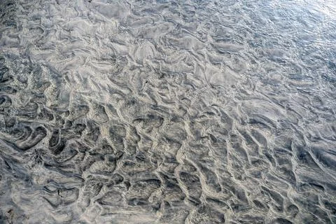 A captivating high-angle, close-up view of an abstract seabed or tidal flat, Stock Photos
